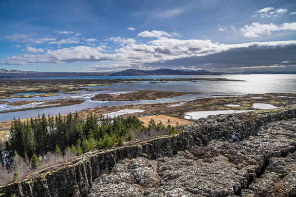 Thingvellir National Park in Iceland. ingvellir or Thingvellir national park in Iceland, is a site of historical, cultural, and geological significance. The Silfra fissure between the North American and Eurasian continental plates located here. - Photo, Image