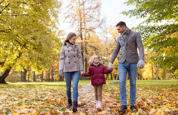 happy family walking at autumn park - Фото, изображение