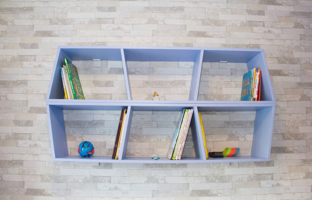 Blue shelf for booksChildren's books on the shelf of different authors, St. Petersburg, June 2018 - Фото, зображення