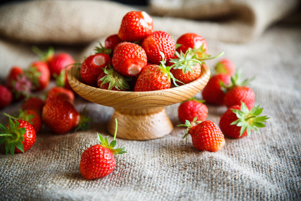 ripe red strawberry on a table with burlap - Valokuva, kuva