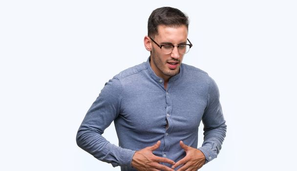 Handsome young elegant man wearing glasses with hand on stomach because indigestion, painful illness feeling unwell. Ache concept. - Photo, Image