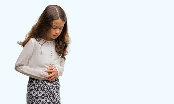Brunette hispanic girl with hand on stomach because nausea, painful disease feeling unwell. Ache concept. - Фото, зображення