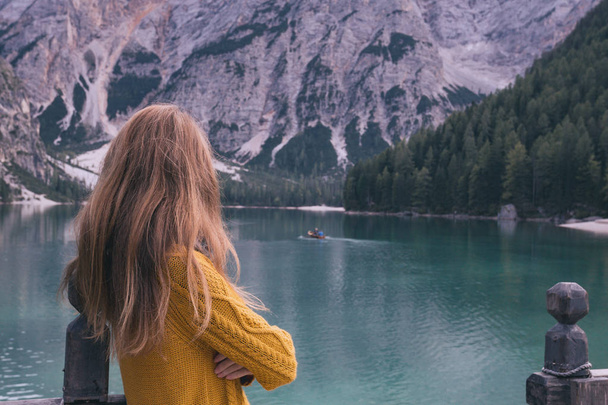 autumn - girl and view of well-known tyrolean lake lago di Braies Dolomites Ital - 写真・画像