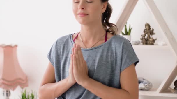 woman meditating in lotus pose at yoga studio - Materiał filmowy, wideo