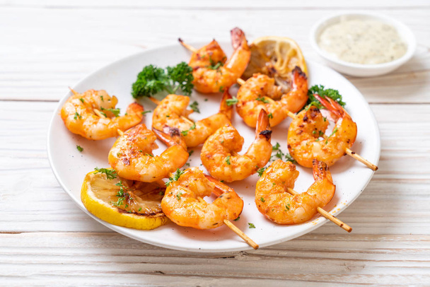 Grilled tiger shrimps skewers with lemon - seafood style - Photo, image