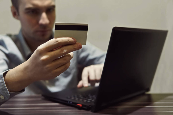 Businessman hand holding credit card and use laptop - Foto, Imagen
