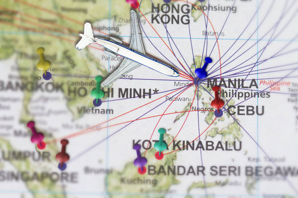 Trip to Manila with toy airplane and push pin  on map of The Philippines - Photo, Image