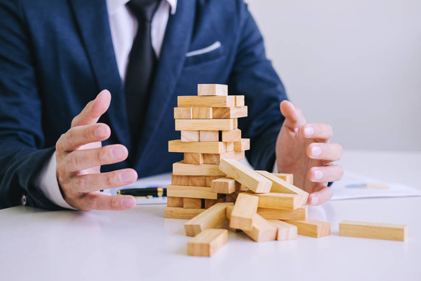 Alternative risk concept, plan and strategy in business protect with balance wooden stack with hand control risk shape. - 写真・画像