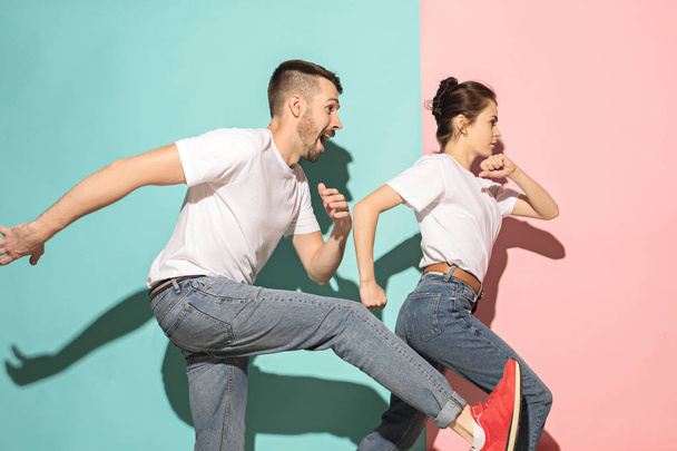 A couple of young man and woman dancing hip-hop at studio. - Fotó, kép