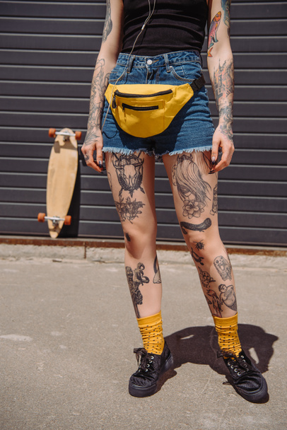 cropped image of stylish tattooed woman with waist bag  - Fotoğraf, Görsel