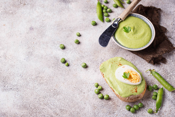 Bruschetta with green peas puree and egg - Photo, Image