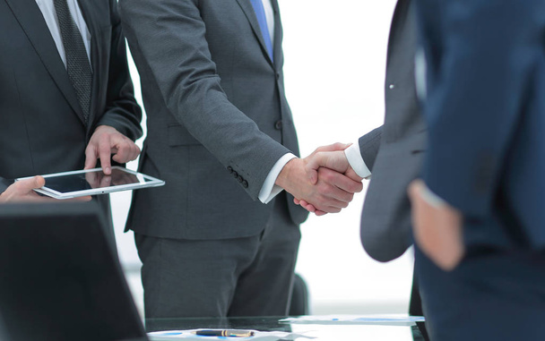 Business partners handshaking with their colleagues. - Foto, Imagem
