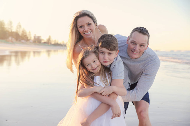 Family of four portrait on the beach, soft selective focus, toning - Photo, image