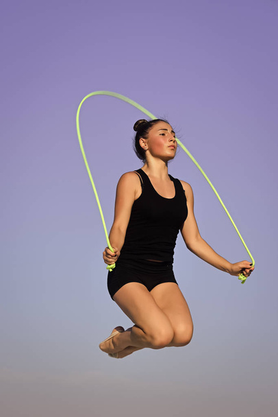 jumping rope. Flexibility in acrobatics and fitness health. - Фото, изображение