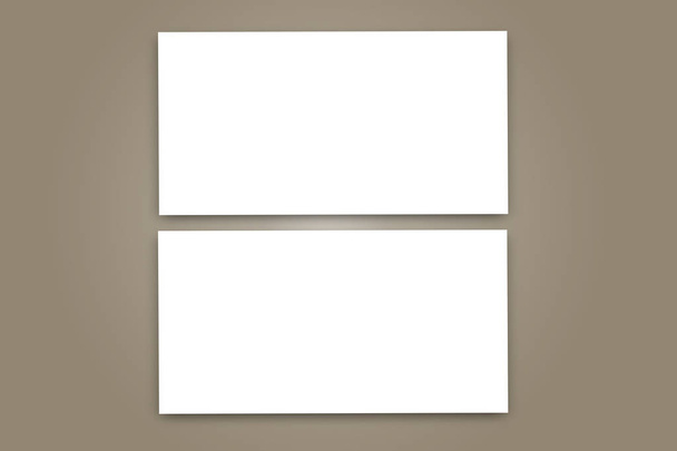 Vista superior con maqueta universal de dos tarjetas bancarias colocadas verticalmente con sombras sobre un fondo gris
. - Foto, Imagen