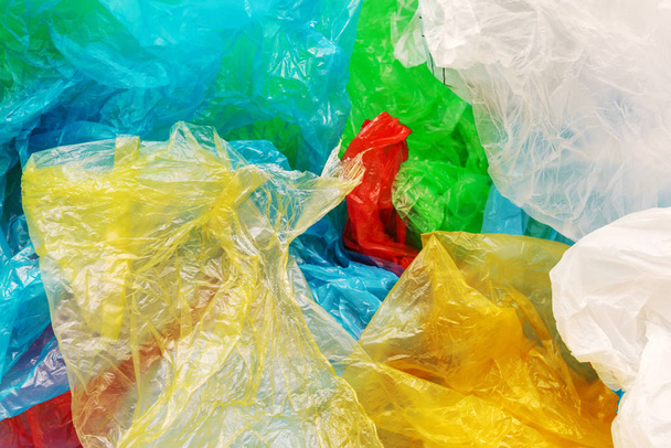 Pile of colorful plastic bags, consumerism and environmental pollution concept - Foto, Imagem