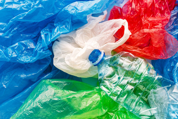 Pile of colorful plastic bags and bottle, consumerism and environmental pollution concept - Zdjęcie, obraz