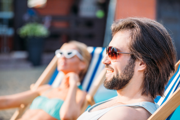 foyer sélectif de sourire homme passant du temps près de la piscine avec sa femme sur la cour arrière le jour de l'été
 - Photo, image