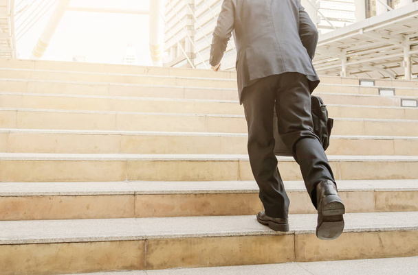 handsome businessman walking or runing on stairs outdoors. - Foto, immagini