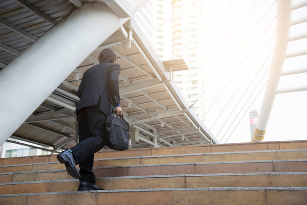 handsome businessman walking or runing on stairs outdoors. - Photo, Image