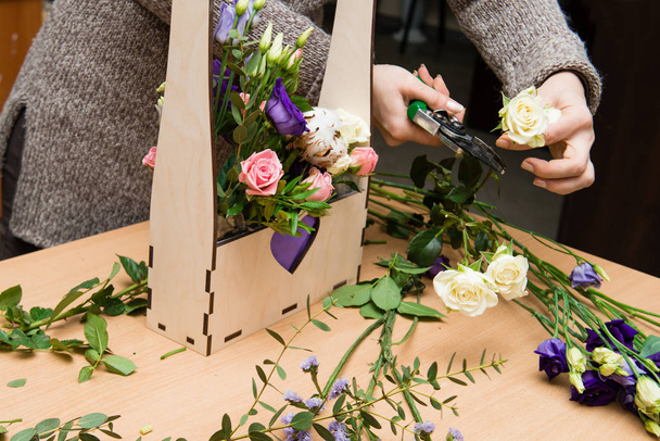 Florist making bouquet girl at work - Fotó, kép