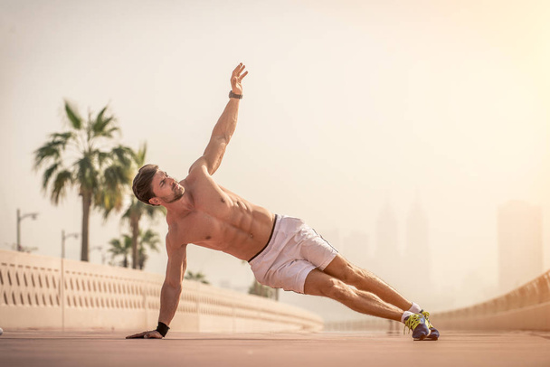 Athletic man doing sport outdoors - Valokuva, kuva