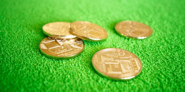 ICO concept - gold coins of electronic currency on a green background. Can be used as an illustration to materials on investments in Initial Coin Offering. - Φωτογραφία, εικόνα