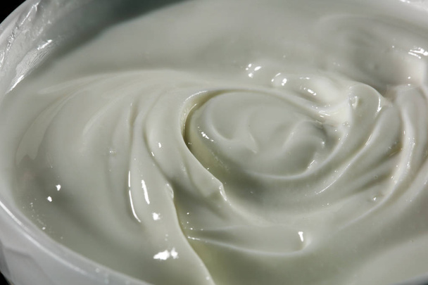 close up of a white whipped or sour cream in bowl - Photo, Image