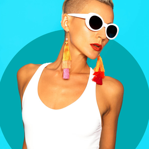 Model in  white swimsuit and stylish beach accessories. Sunglasses and earrings. Beach trend outfit - Zdjęcie, obraz