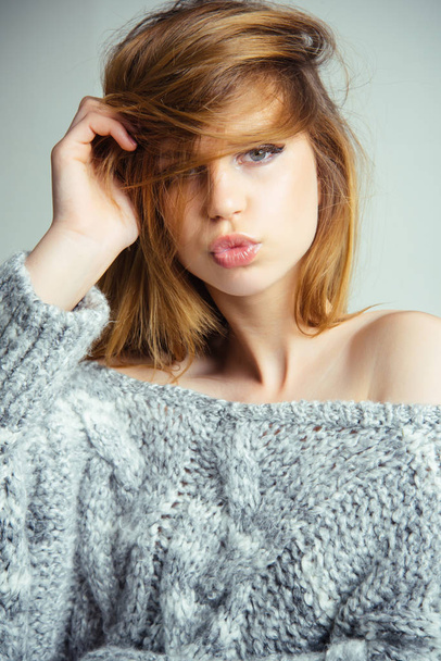 Fashion portrait woman model blowing lips sends air sweet kiss on grey background - Foto, Imagen