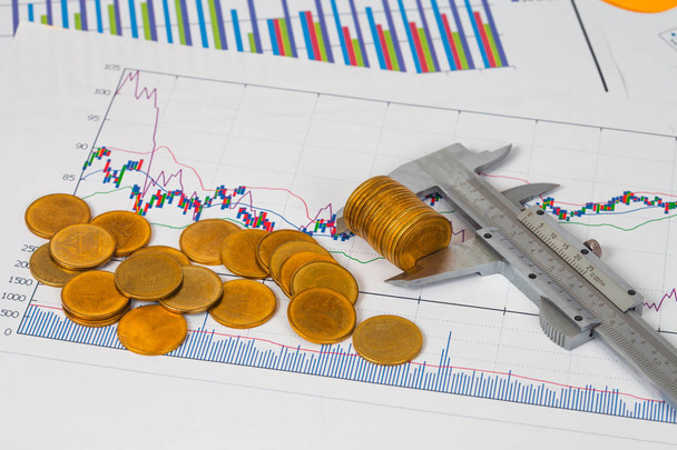 vernier measuring money coin on business chart, business concept
. - Фото, изображение