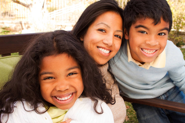 Biracial family laughing and smiling outside. - Photo, Image
