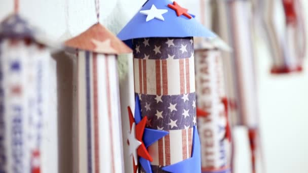 Paper firecrackers made from red, white and blue paper for July 4th celebration - Imágenes, Vídeo