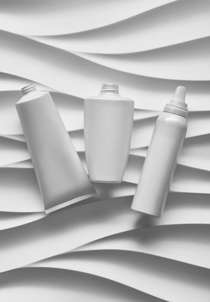 Beautiful format poster with Smooth Grey Waves abstract background with grayish tonalities, with clean white plastic containers: bottles, cream jar, tube. Realistic mock-up of cosmetic package - Φωτογραφία, εικόνα