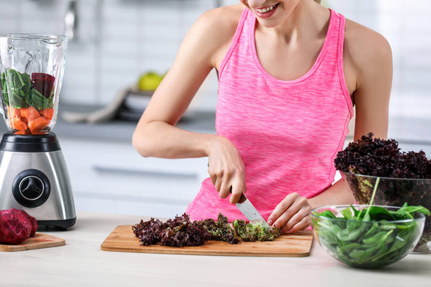 Young woman preparing tasty healthy smoothie at table in kitchen - Photo, Image