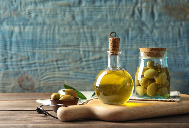 Composition with fresh olive oil on table - Foto, Imagen