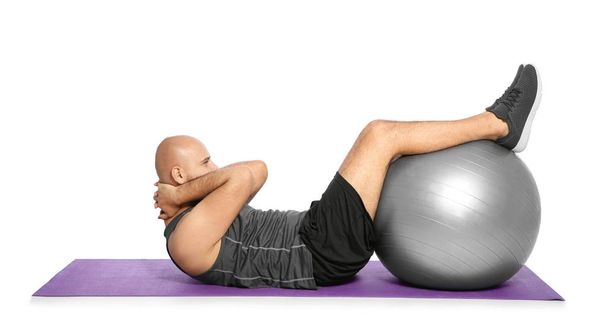 Overweight man doing exercise with fitness ball on white background - Valokuva, kuva