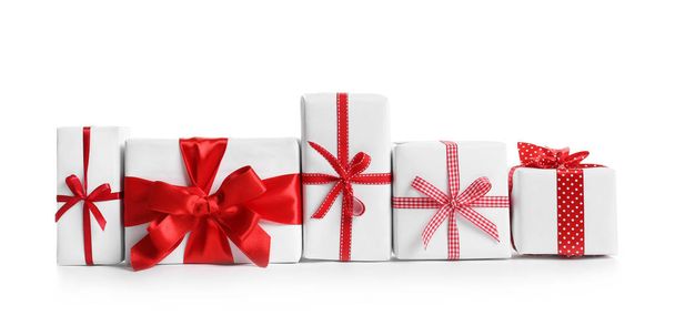 Beautifully wrapped gift boxes on white background - Photo, image