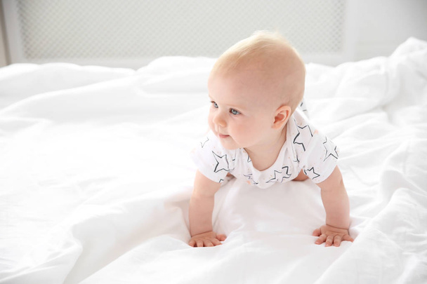 Cute little baby crawling on bed at home - Photo, Image