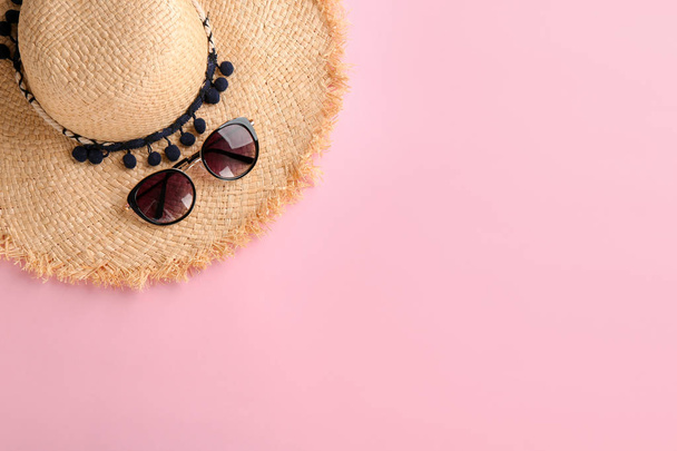 Stylish hat and sunglasses on color background, top view - Фото, зображення