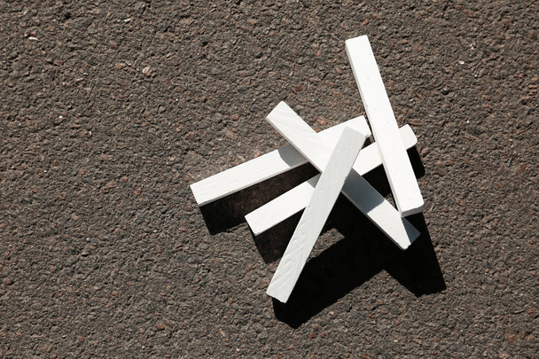 White chalk sticks on asphalt, top view - Valokuva, kuva