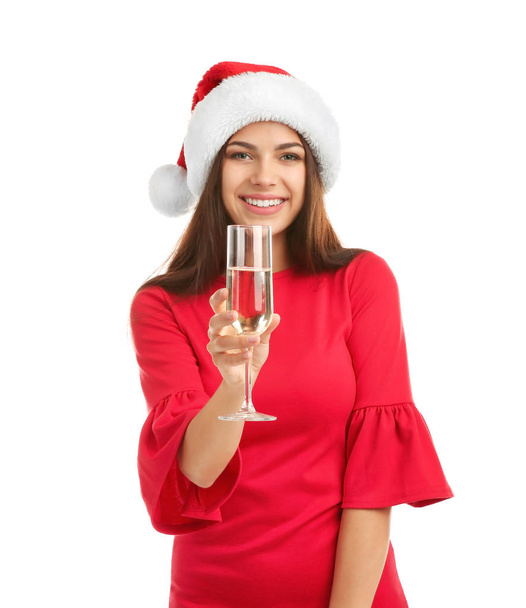 Young beautiful woman in Santa hat holding glass of champagne on white background. Christmas celebration - Foto, Bild