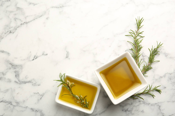 Square bowls of rosemary oil on light background, top view - Foto, Imagem