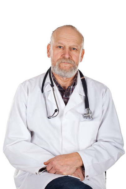 Portrait of mature medical doctor with white coat and stethoscope on isolated background - Zdjęcie, obraz