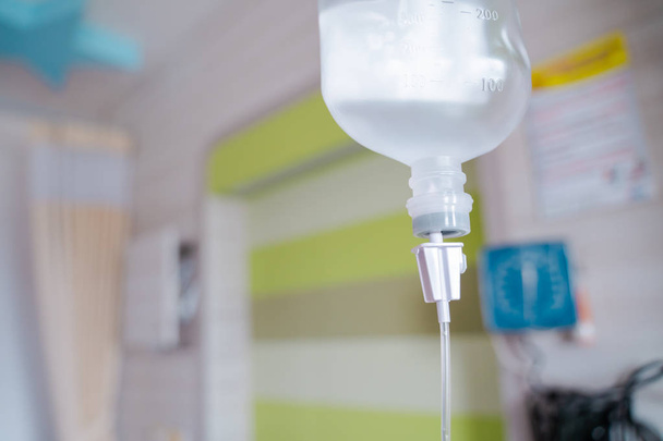 Close up saline solution drip for patient and infusion pump in hospital, Treatment of the disease of the doctor concept. - Photo, Image