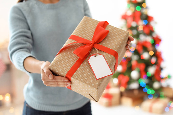 Young woman with Christmas gift at home - Photo, Image