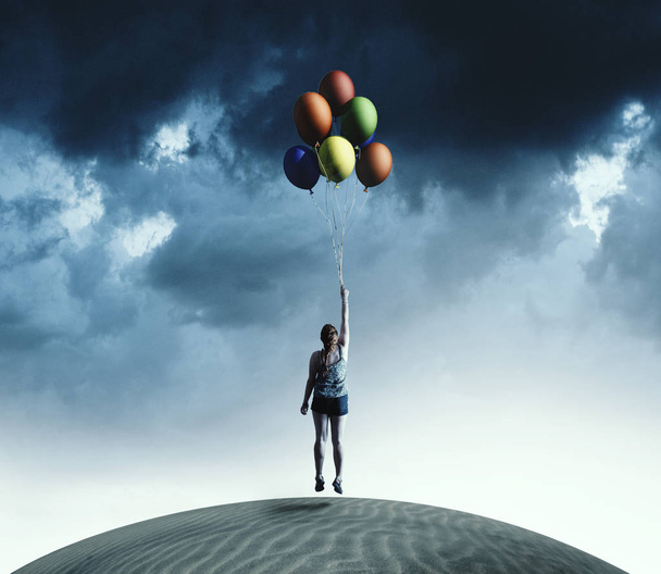 Woman taking off the ground holding colorful balloons. - Foto, immagini
