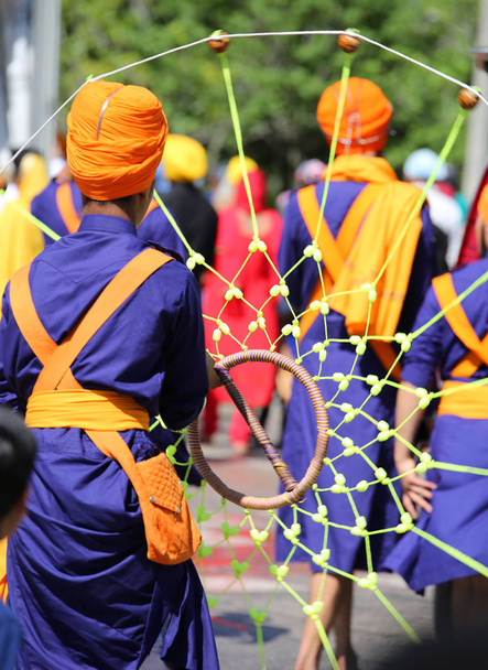 Sikhs with a traditional dress and a traditional game during a religious celebration - Photo, Image