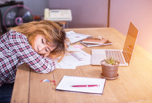 Young business woman tired and headache about her work. - Foto, imagen