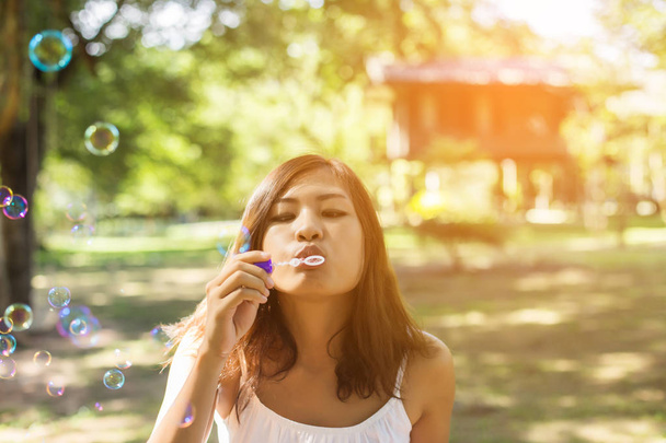 a beautiful woman blowing bubbles - Foto, afbeelding